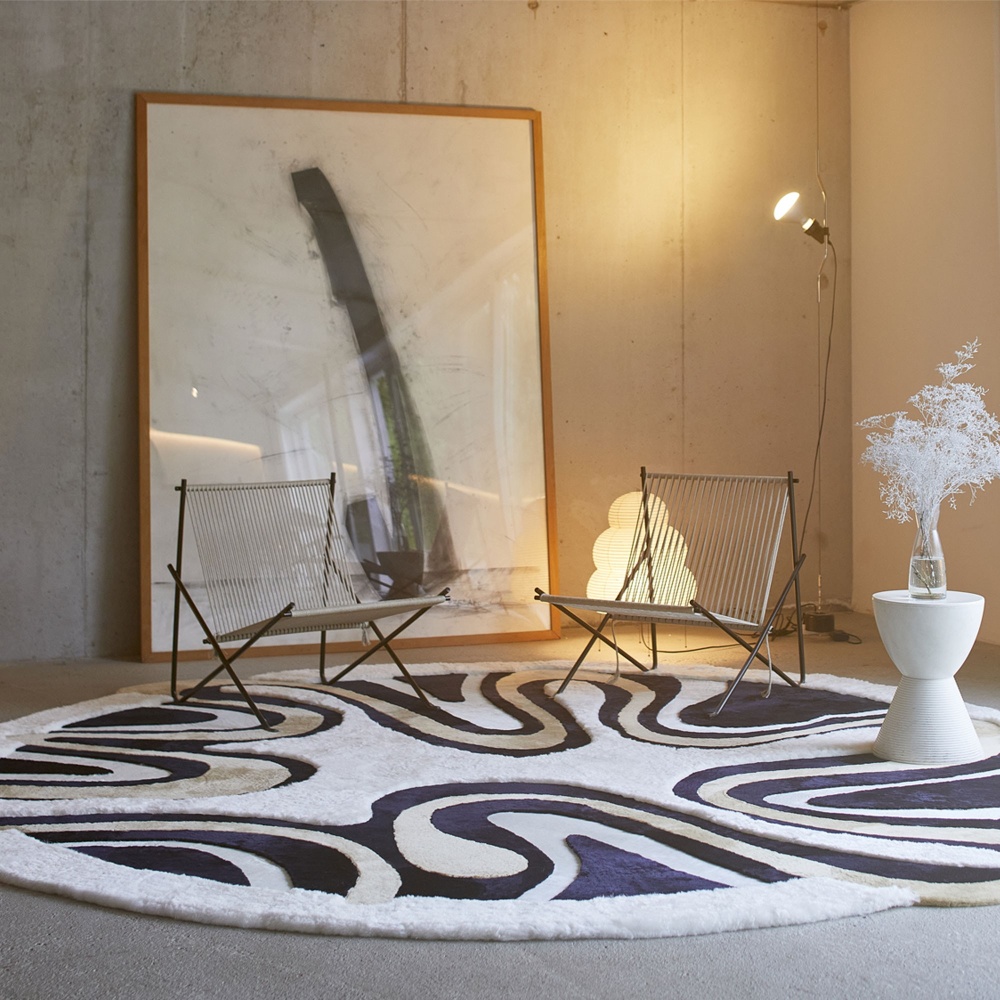 A large round rug for a very designer, upmarket interior.