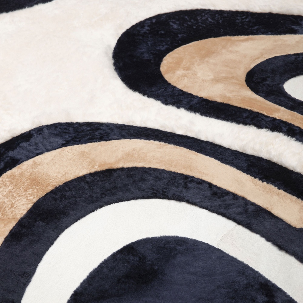 The carpet pattern is made up of harmonious round lines in shades of navy blue, white and beige.