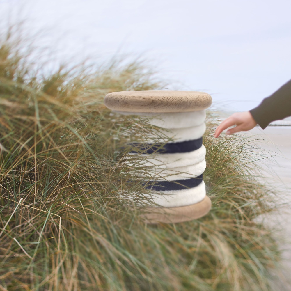 High-end stool, small designer furniture in navy blue and white, wooden structure.