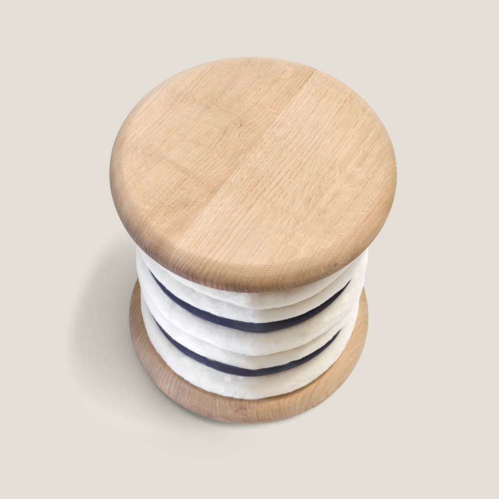 Round designer pouf in wood and sheepskin that can also be used as a small side table