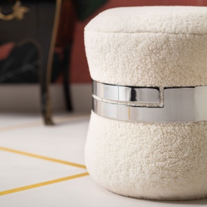 Luxury shearling stool, surrounded by a shiny nickel-plated metal ring, Norki design