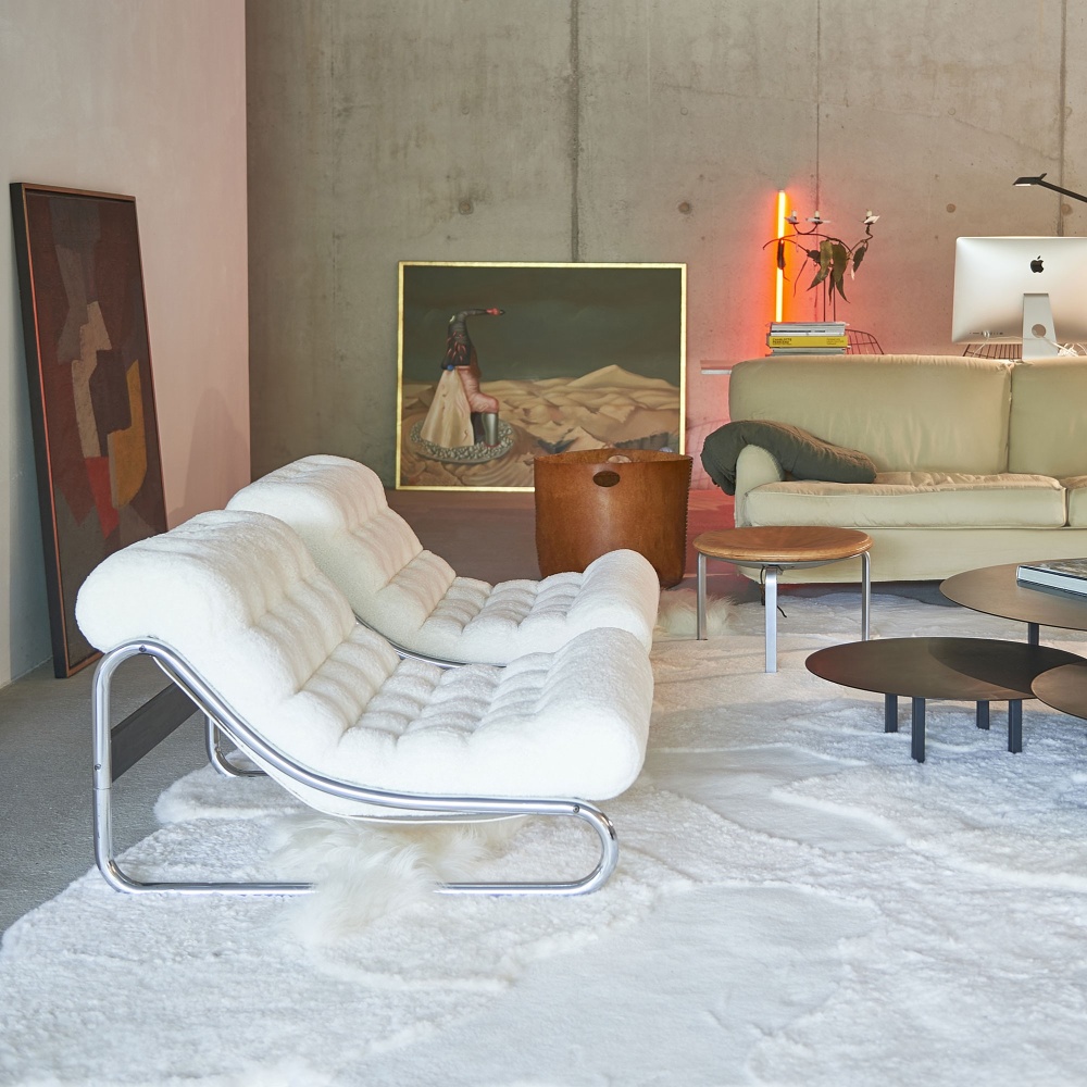 Fauteuils confortables dans un salon vintage avec un grand tapis Khan blanc.