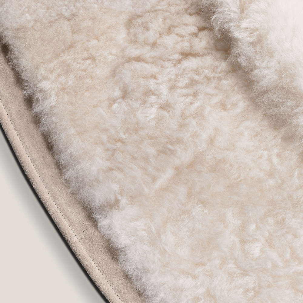 Round white sheepskin rug with a fine suede leather border