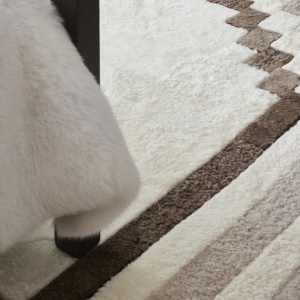 Square rug in natural hide with chic geometric patterns in a variation of beige