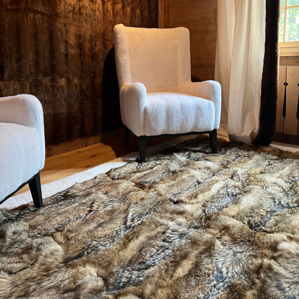 Fur rug and white St. Moritz mink armchairs for a luxurious mountain chalet in Gstaad.