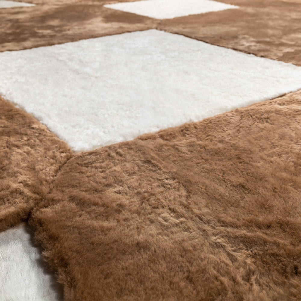 Rug in camel-dyed shaved sheepskin, natural white curly shearling and natural white foal.