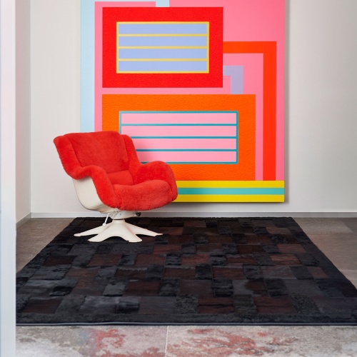 Embossed Black rug with an artwork by Peter Halley as well as a pair of vintage Kukkapuro armchairs.