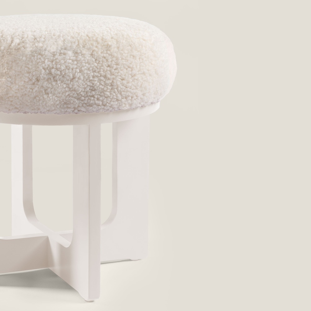 Large, high quality, luxury white ottoman with lacquered wooden legs and a shearling seat