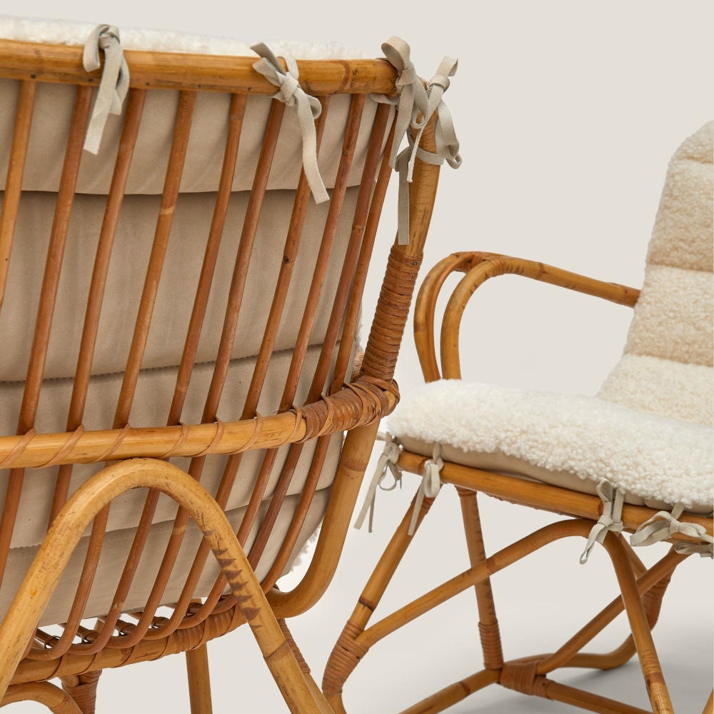 Natural white French curly shearling cushion with suede leather bows.