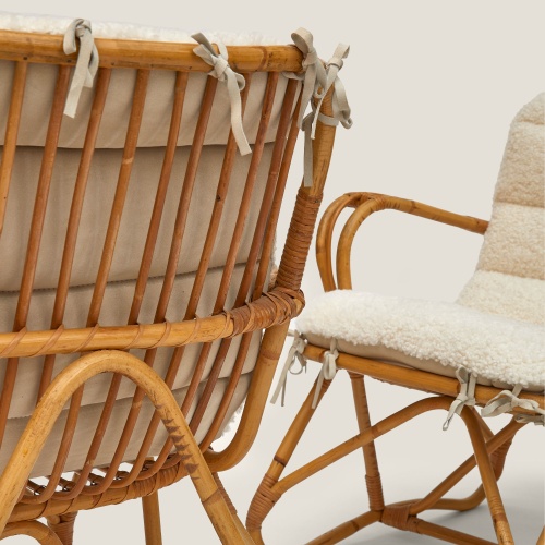 Natural white French curly shearling cushion with suede leather bows.