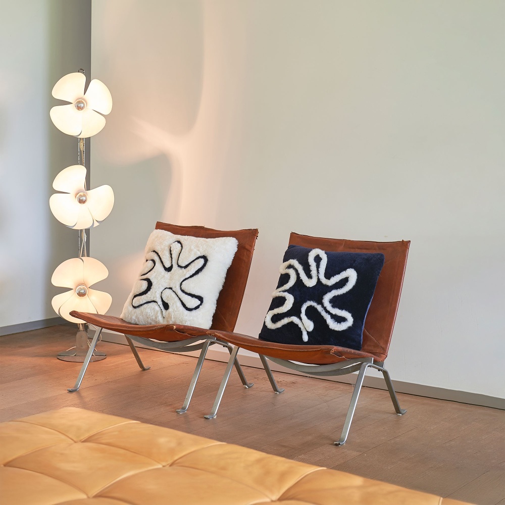 Our two Étretat cushions on two Scandinavian-style chairs.