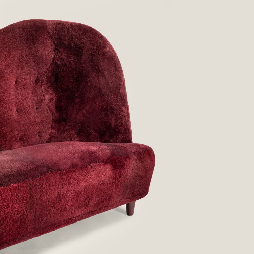 Small sofa in burgundy sheepskin with a fully padded back