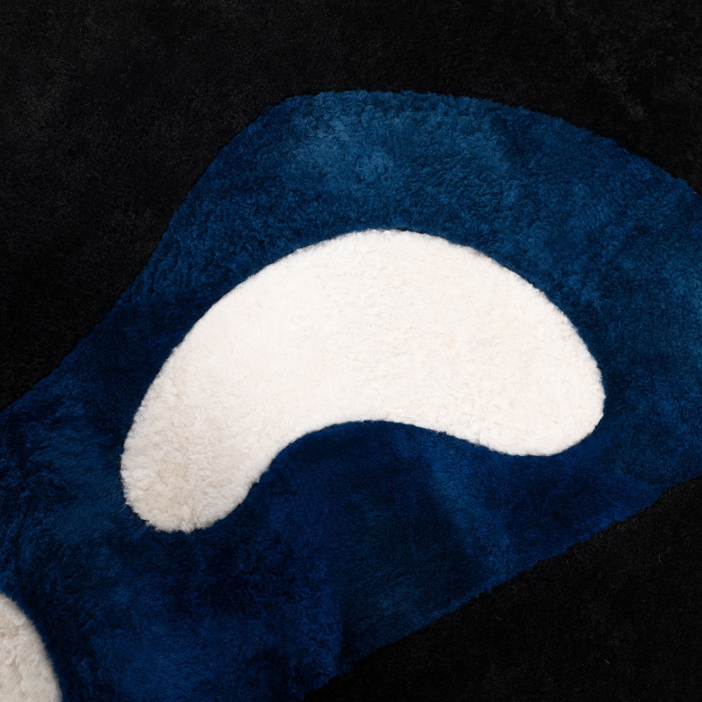 Touches of white enhance the Klein blue and black of the Norki's rug.