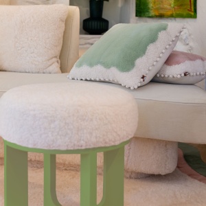 Elegant white and pastel green stool, curly shearling seat, lacquered wooden legs.