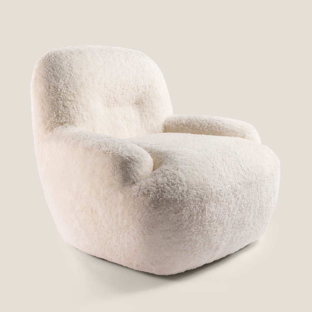 Small, comfortable and elegant white designer armchair, mounted on a 360° swivel metal base.