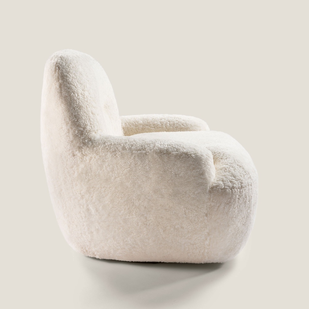 A small white armchair with rounded, enveloping curves, described by its little name Bao.