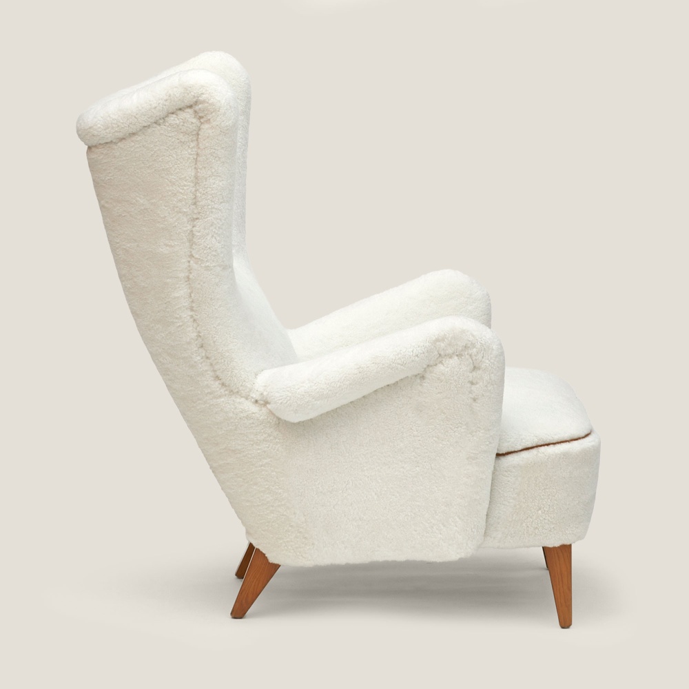 Luxurious vintage armchair in white shearling, unique piece of Scandinavian design