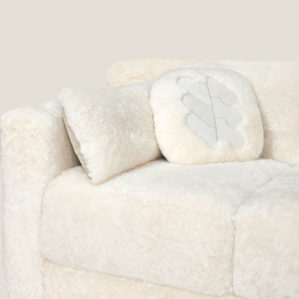 White natural skin cushion on white sofa.