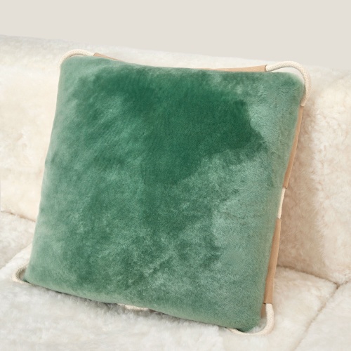 One side in almond green shorn shearling. A luxury cushion.