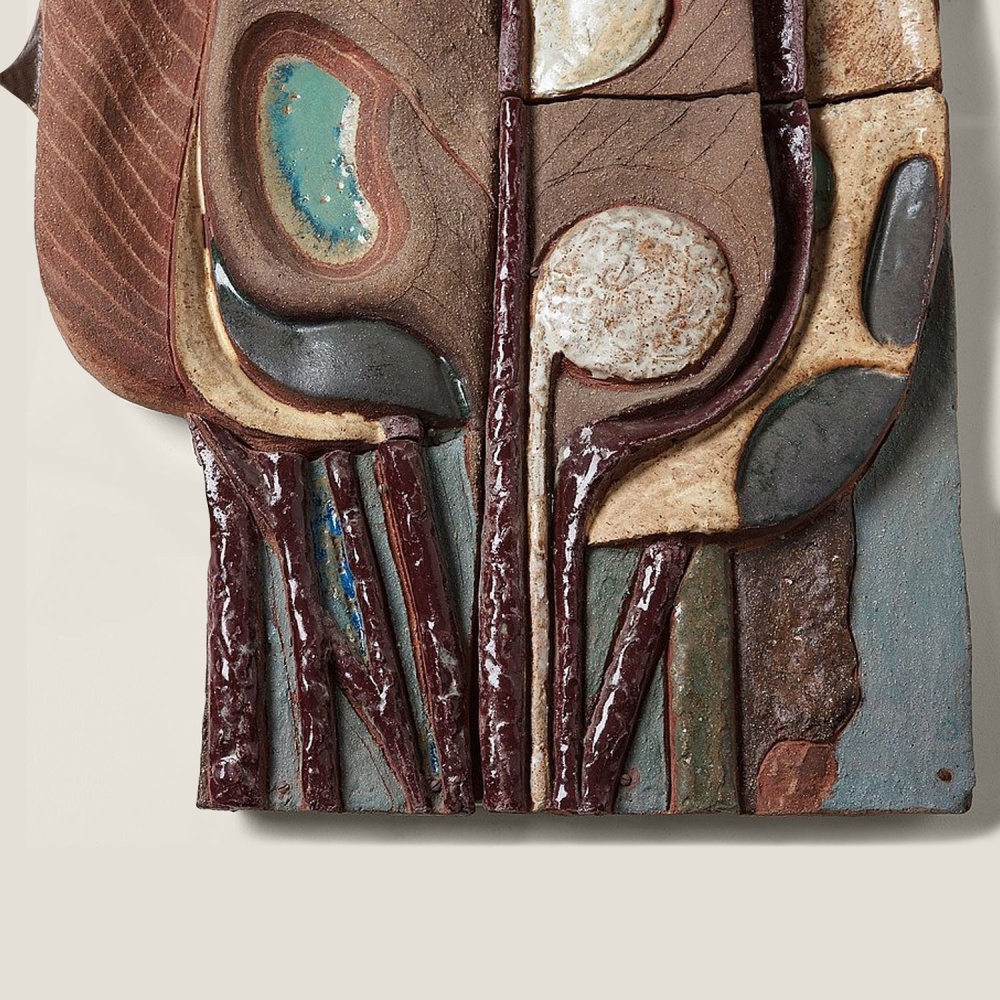 Ceramic wall relief, molded on a wooden plaque.