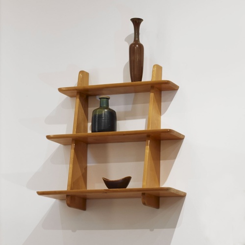 Stoneware bowl and vase on a wooden shelf.