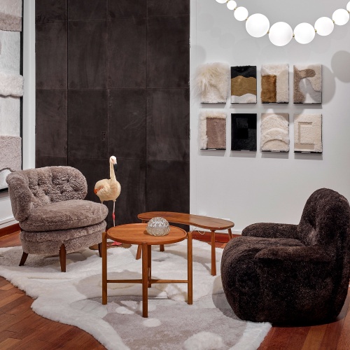 Brown shearling armchair and small vintage tables restored by Atelier Norki.