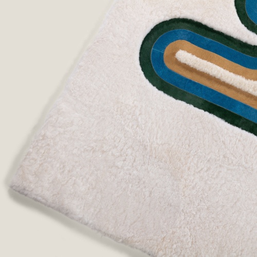 Bold colors form a contrasting pattern against the deep white of this modern rug.