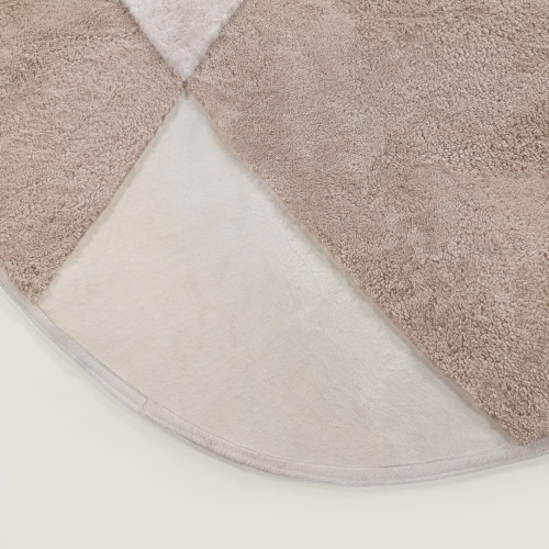 Rug in natural white shorn sheepskin, beige curly shearling and natural white cowhide.