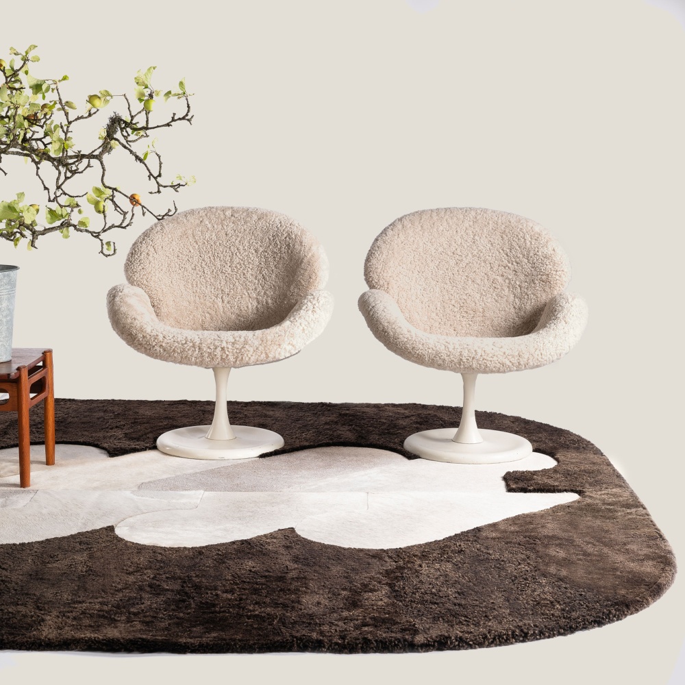 Pair of Orchid armchairs by Aage Egeriis on a beige and brown hide rug.