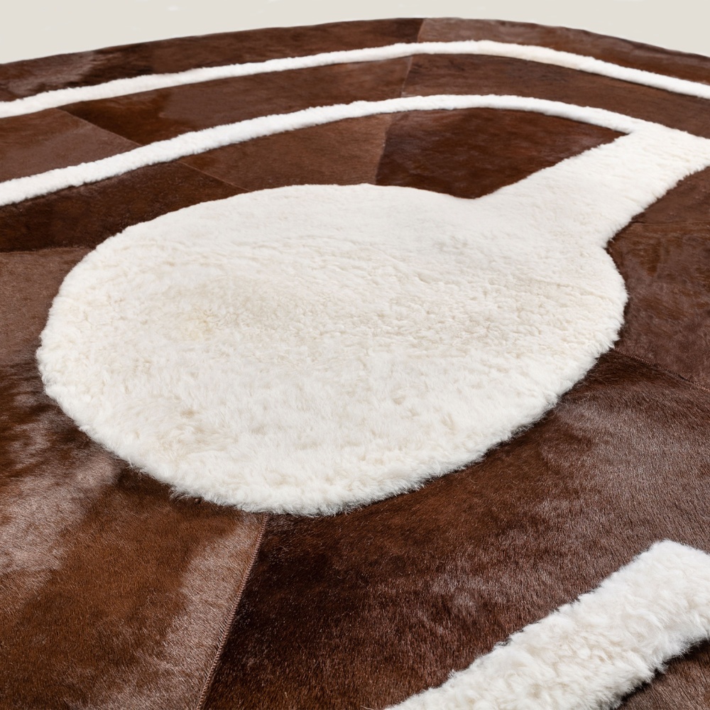 Abstract pattern in white sheepskin and brown cowhide for this designer rug.