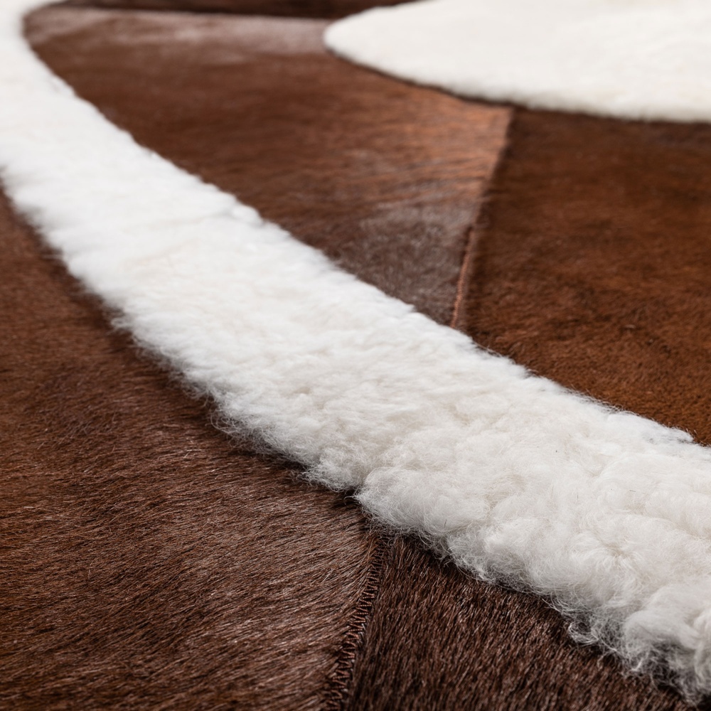 Luxury piece in natural white sheepskin on a brown-dyed cowhide background.