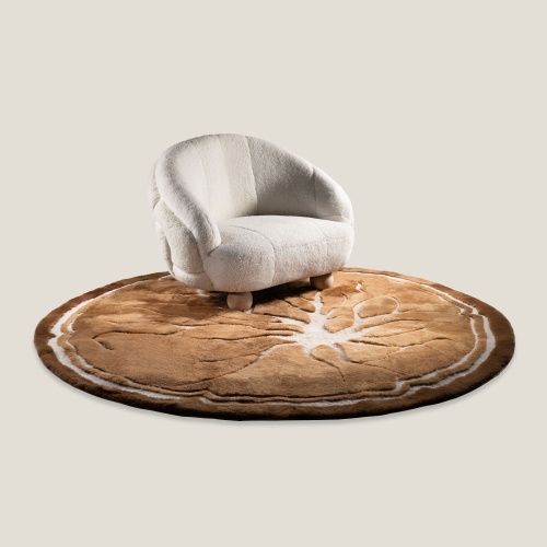 Round caramel rug in harmony with the curves of a white designer armchair.