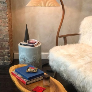 White sheepskin sofa with tapered legs. Sizes W 2,3 × H 3 × D 2,5 ft. A Maison Norki signature.