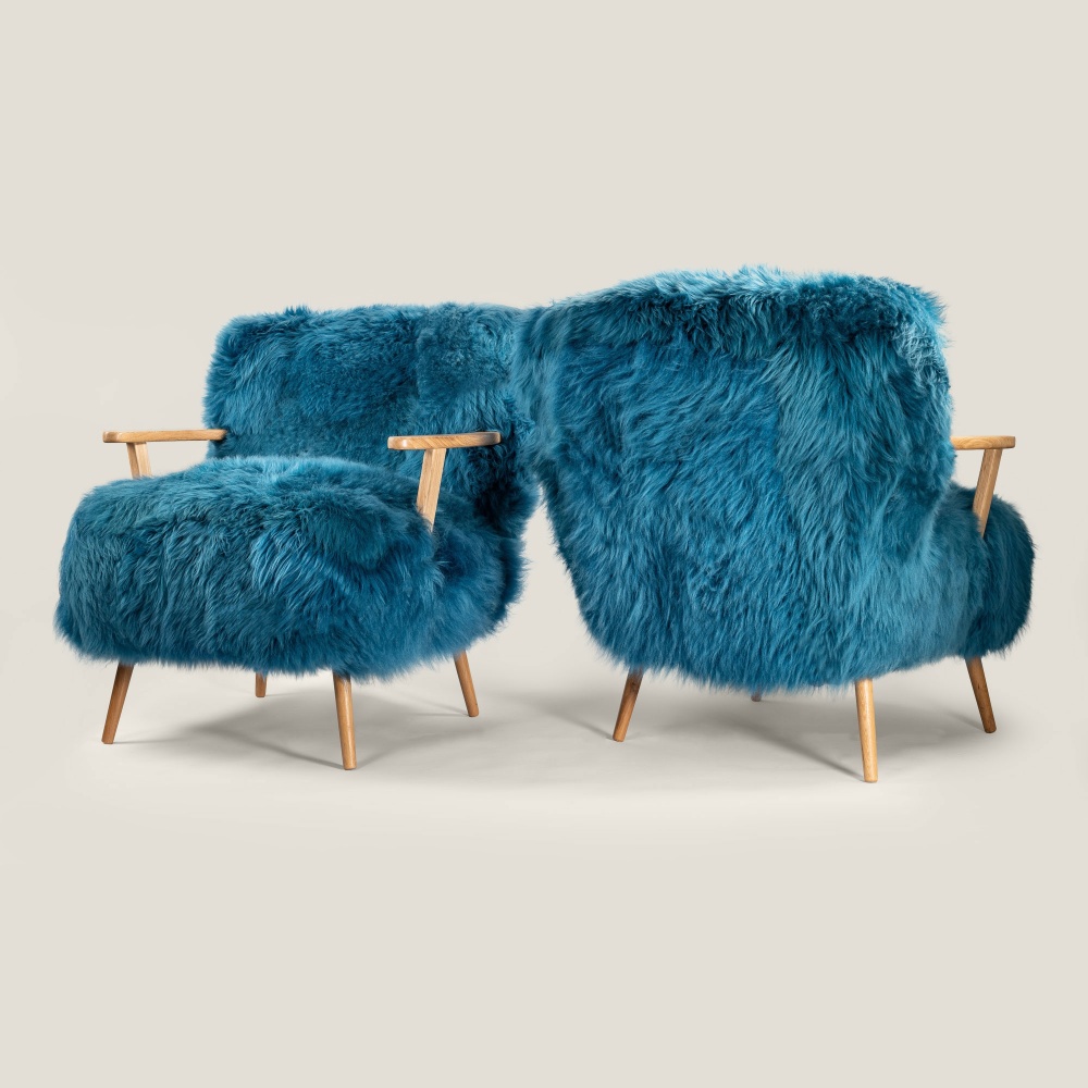 A luxurious pair of designer armchairs in a bold, elegant blue. Norki's signature armchairs.