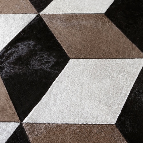 Hand-sewn rug in natural white cowhide and beige and black dyed cowhide.