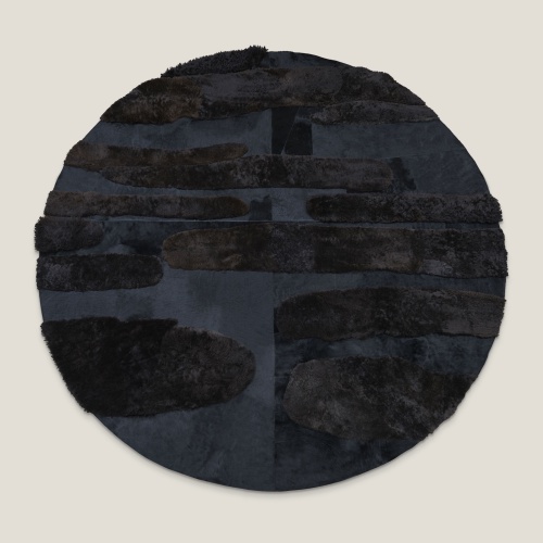 Round black hide rug diameter 370 cm with chic embossed patterns, design by Maison Norki