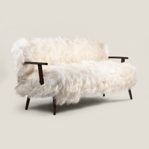 Charming sofa upholstered in long-haired white sheepskin with attractive black-stained solid oak legs and arms.