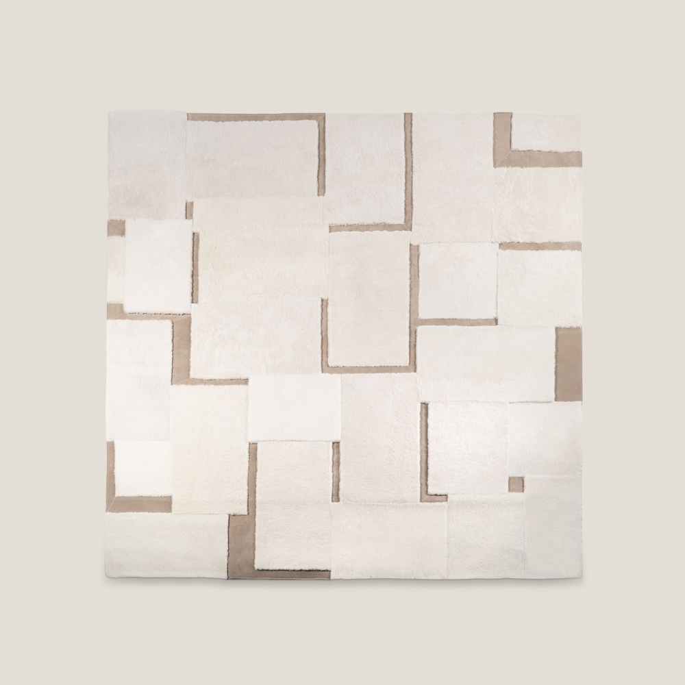 Designer rug in light tones and rectangular patterns. An elegant hides and leather white an beige rug by Norki.