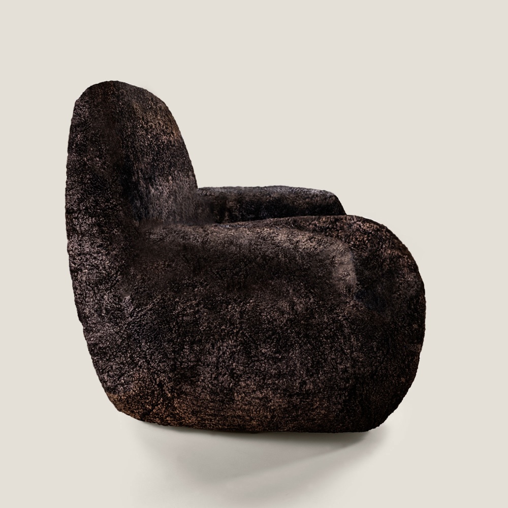 A small, rounded armchair with a cleverly designed profile. A signature piece from the French Maison Norki.