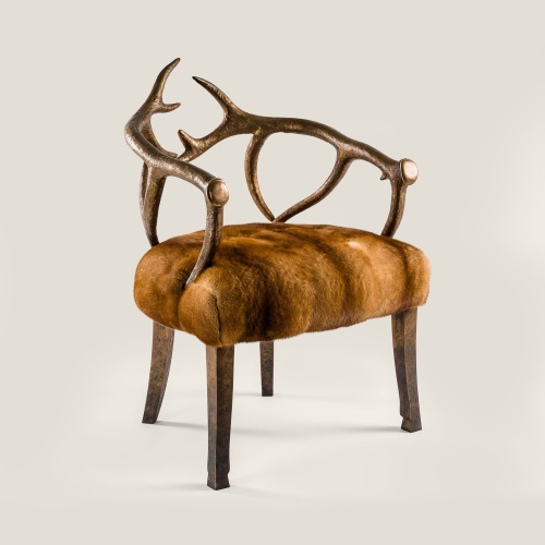 High-end ceremonial armchair in solid bronze with golden mink fur seating. The luxury of a collector's furniture item.