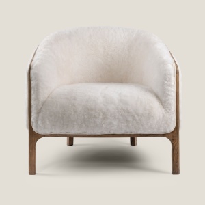 Comfortable bedroom armchair in natural white shearling. Luxurious high-end furniture available in black.