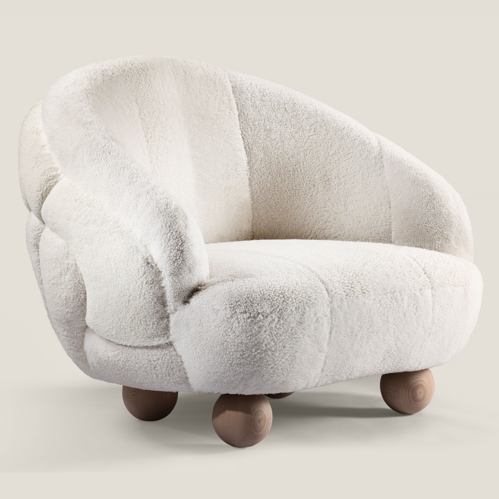 Large white designer armchair by NORKI. Natural solid oak ball feet, white curly shearling. Luxury made in FRANCE.