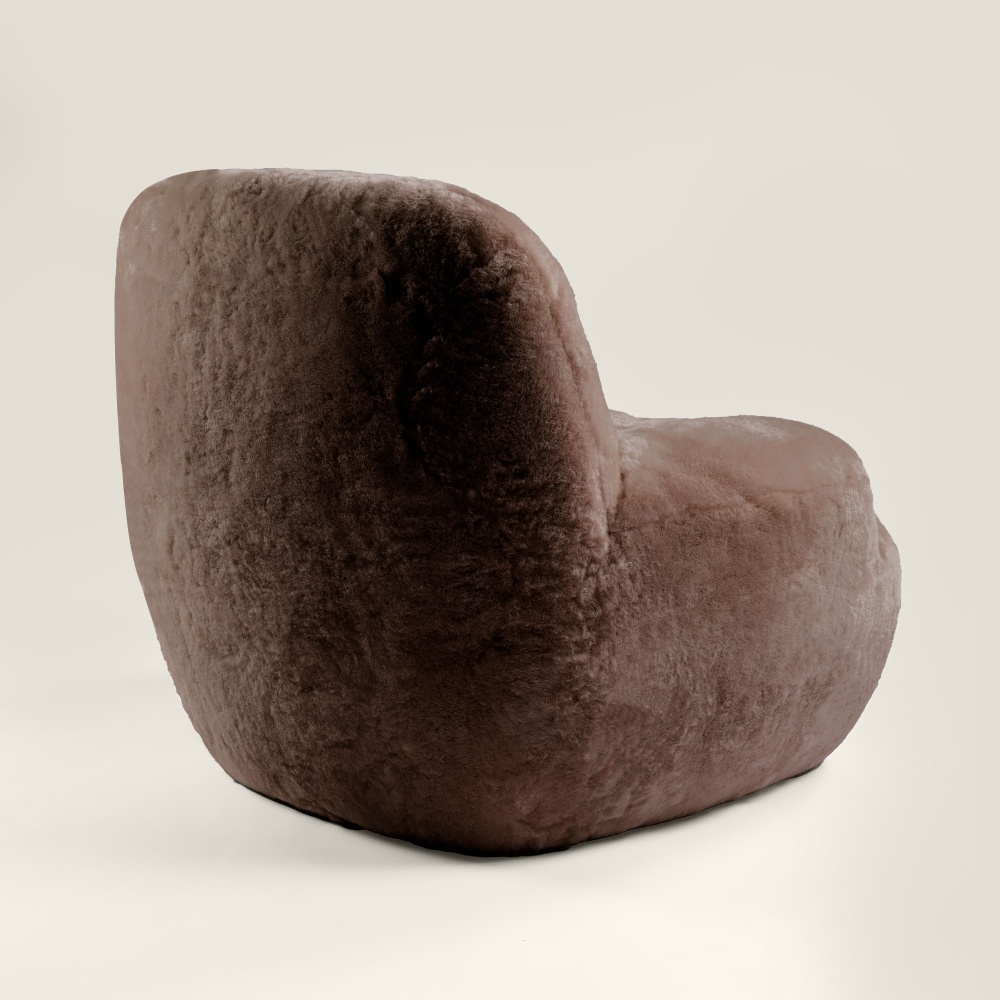 This small brown armchair with wide back is designed for your home. It will find its place in an office or hallway.