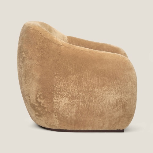 Wrap-around curves and absolute comfort for the golden-beige COCO armchair by Maison Norki.