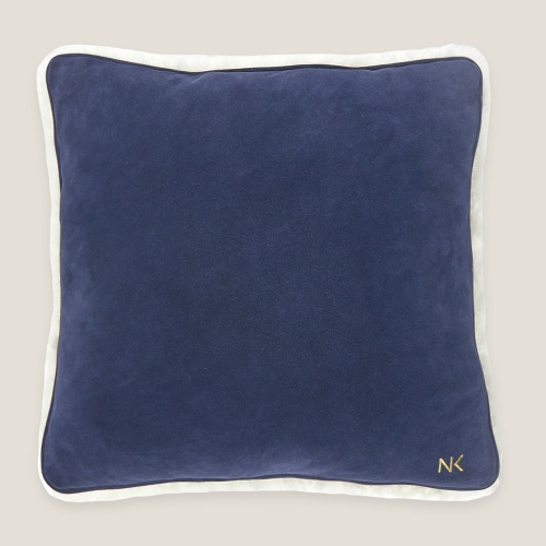 One side of the cushion is entirely blue, with no pattern, contrasting with the white side.