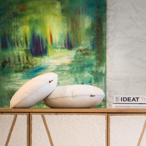 Solid walnut sideboard decorated with round white pancake cushions with a painting by Flore Sigrist