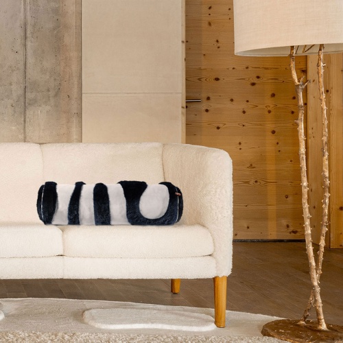 Vintage Hans Wegner sofa decorated with a luxurious navy blue sheepskin cushion for absolute comfort