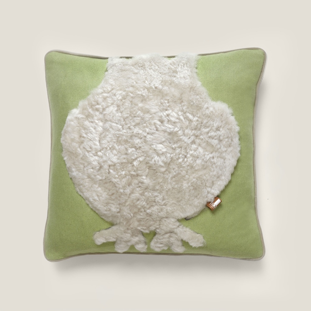 Almond green square cushion with a childish and playful owl pattern in gray sheepskin