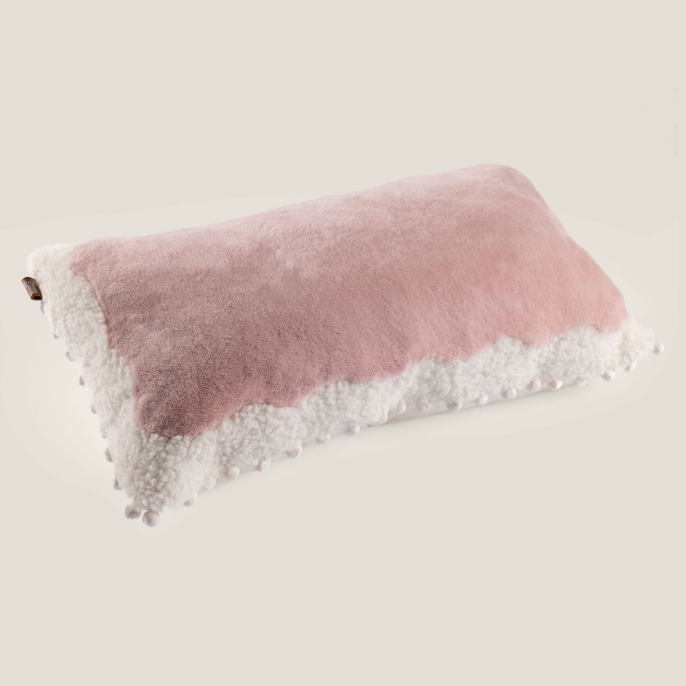 A soft pink cushion by La Maison Norki for soft decoration.