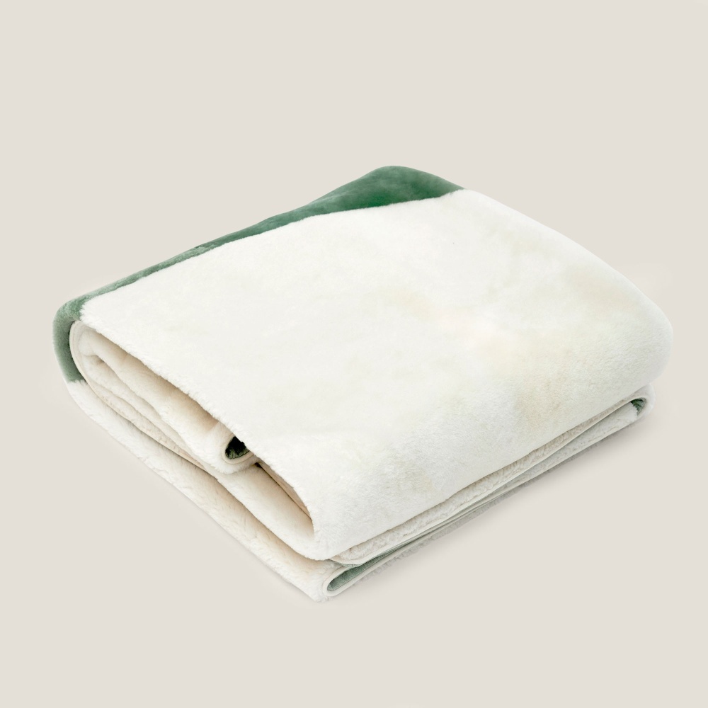 Luxury designer white and almond green throw in natural material by Ateliers Norki